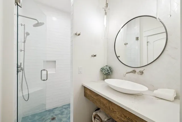 a bedroom with a large bed and a chandelier