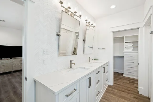 a bedroom with a bed and a mirror