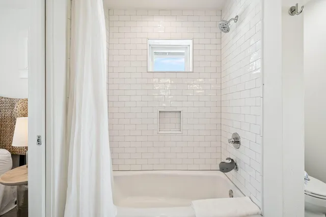 a bedroom with two beds and painting on the wall