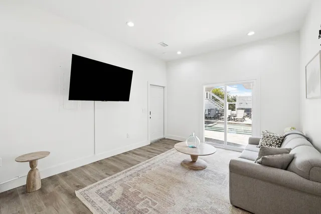 a bedroom with a bed a chair and dresser