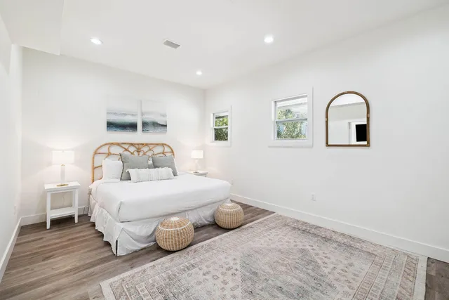 a bedroom with a bed a chair and glass door