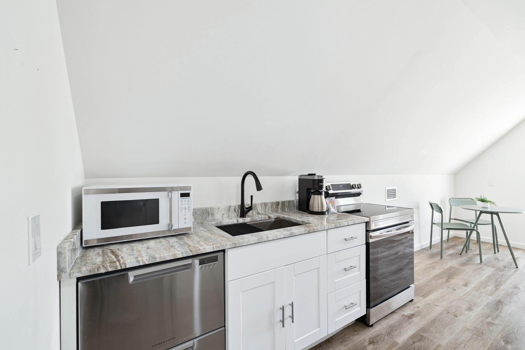 1984 South Co Highway 83 Santa Rosa Beach, FL 32459 - Photo 58 of 70 a kitchen with stainless steel appliances granite countertop a sink and a stove top oven
