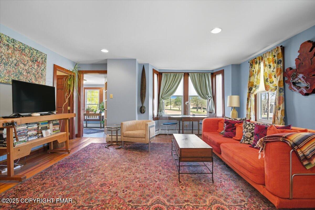 221 Upper Swiftwater Road Mount Pocono, PA 18344 - Photo 15 of 86 a living room with furniture a flat screen tv and a floor to ceiling window