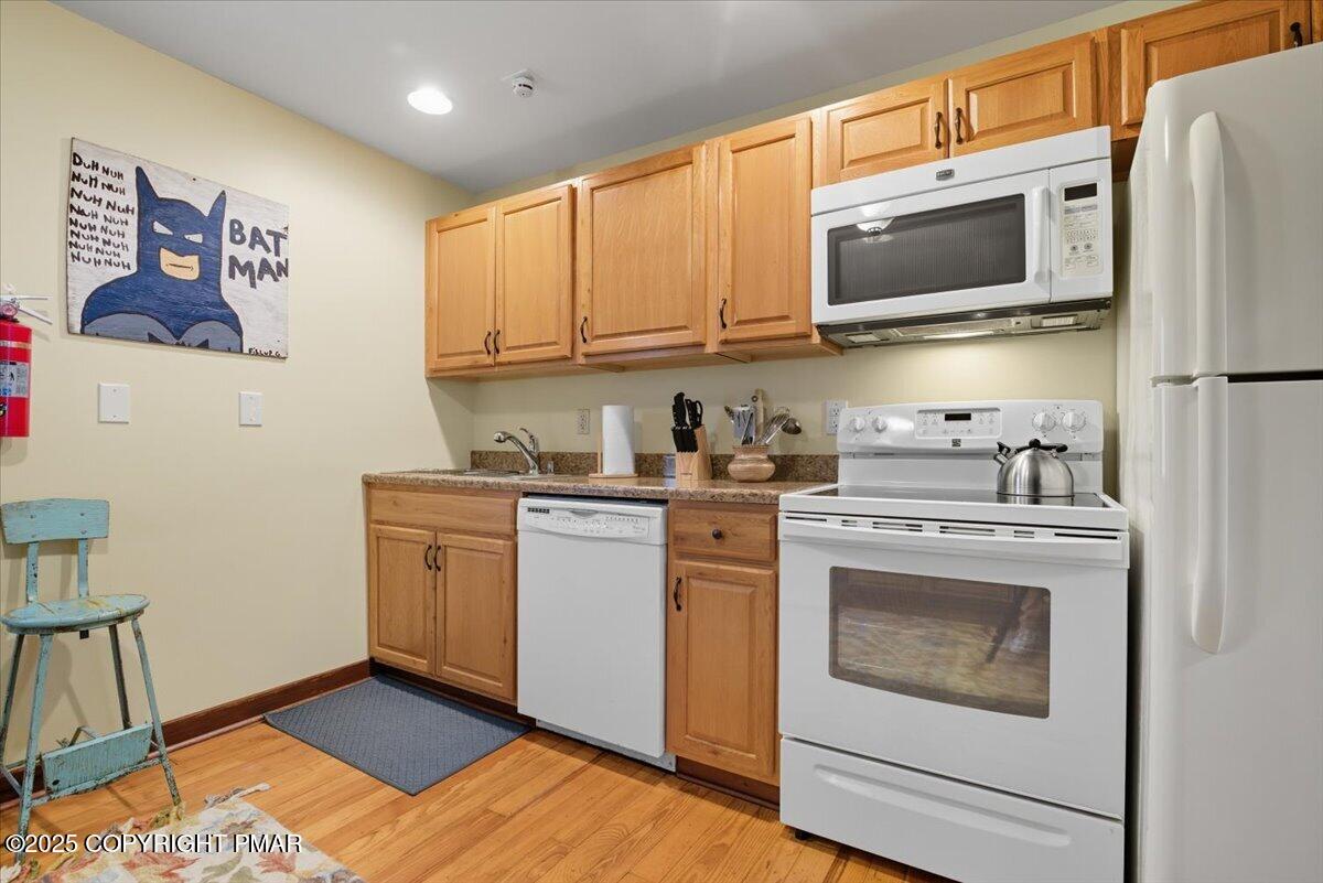 221 Upper Swiftwater Road Mount Pocono, PA 18344 - Photo 19 of 86 a kitchen with stainless steel appliances granite countertop a refrigerator a stove top oven a sink and dishwasher