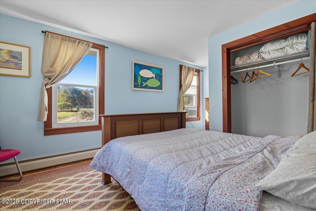 221 Upper Swiftwater Road Mount Pocono, PA 18344 - Photo 28 of 86 a bedroom with a bed and a painting on the wall