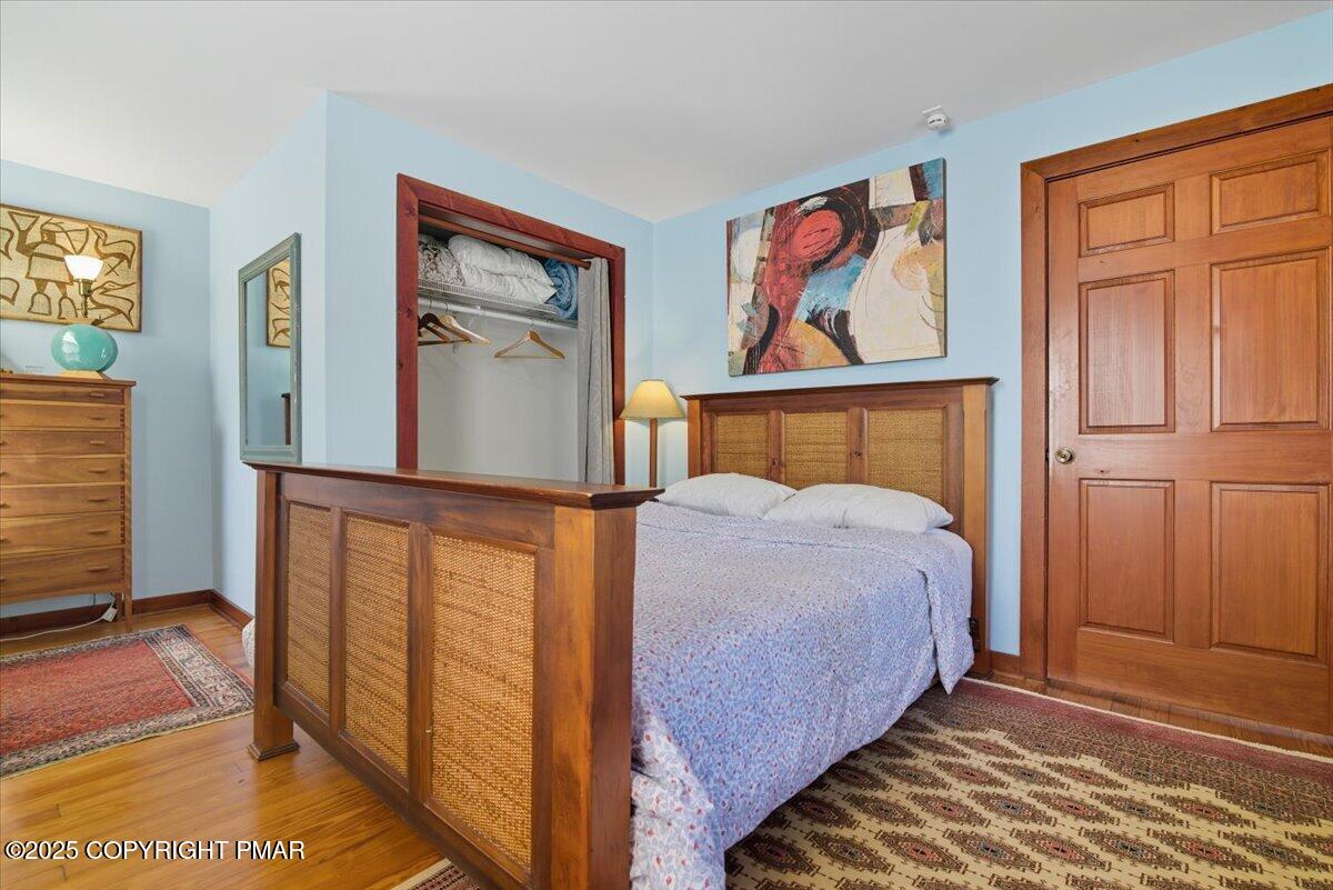 221 Upper Swiftwater Road Mount Pocono, PA 18344 - Photo 29 of 86 a bedroom with a bed and wooden floor