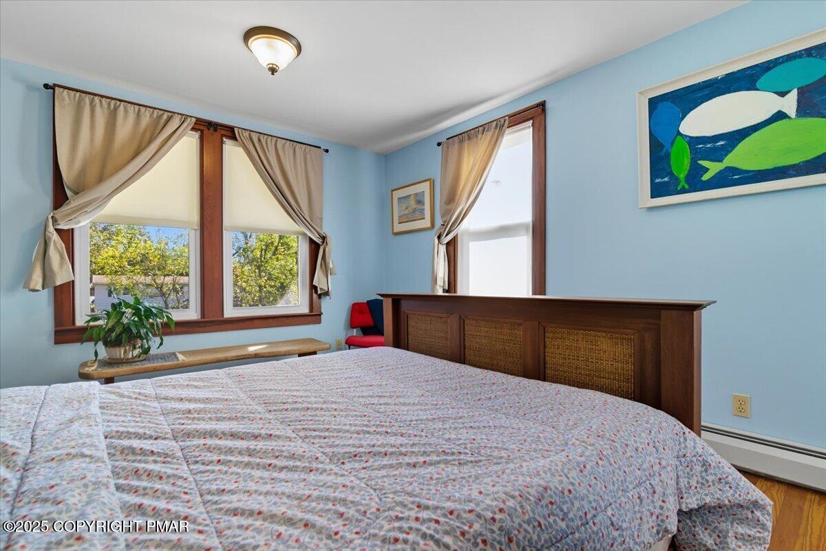 221 Upper Swiftwater Road Mount Pocono, PA 18344 - Photo 31 of 86 a bedroom with a large bed and a large window