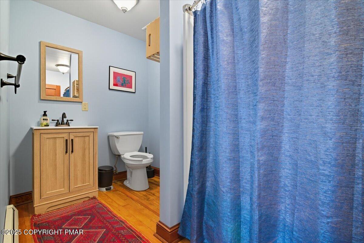 221 Upper Swiftwater Road Mount Pocono, PA 18344 - Photo 32 of 86 a bathroom with a toilet and a shower curtain