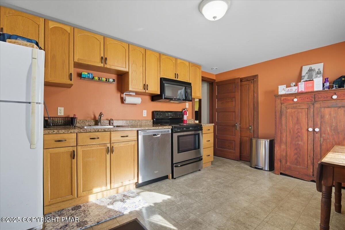 221 Upper Swiftwater Road Mount Pocono, PA 18344 - Photo 39 of 86 a kitchen with stainless steel appliances granite countertop a refrigerator sink and stove