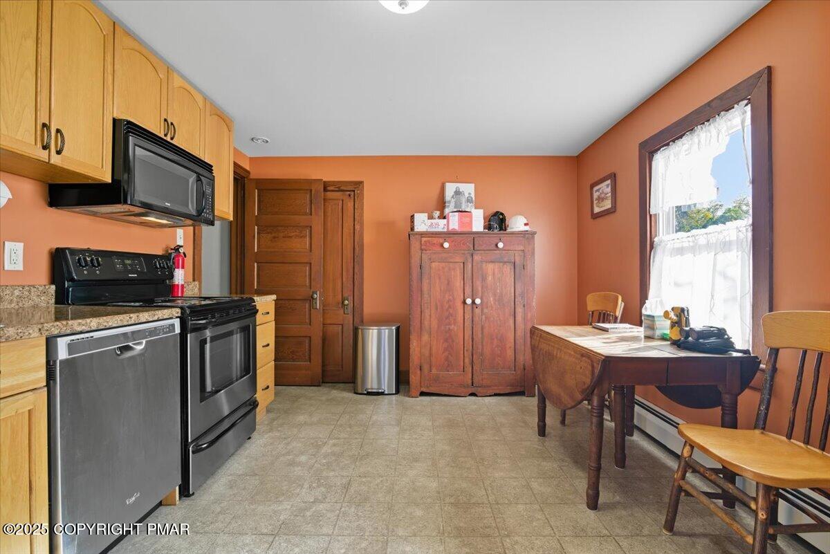 221 Upper Swiftwater Road Mount Pocono, PA 18344 - Photo 40 of 86 a kitchen with stainless steel appliances granite countertop a stove top oven a sink dishwasher a dining table and chairs with wooden floor