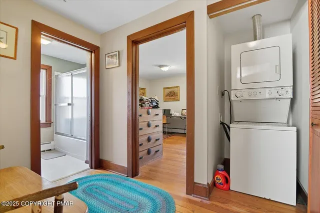 a view of a house with a small yard and a large tree