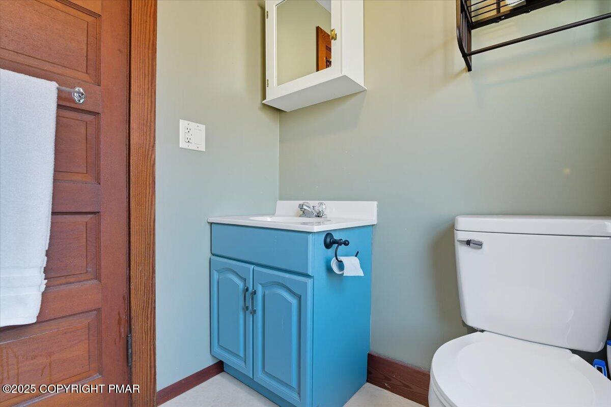 221 Upper Swiftwater Road Mount Pocono, PA 18344 - Photo 53 of 86 a bathroom with a toilet sink and mirror