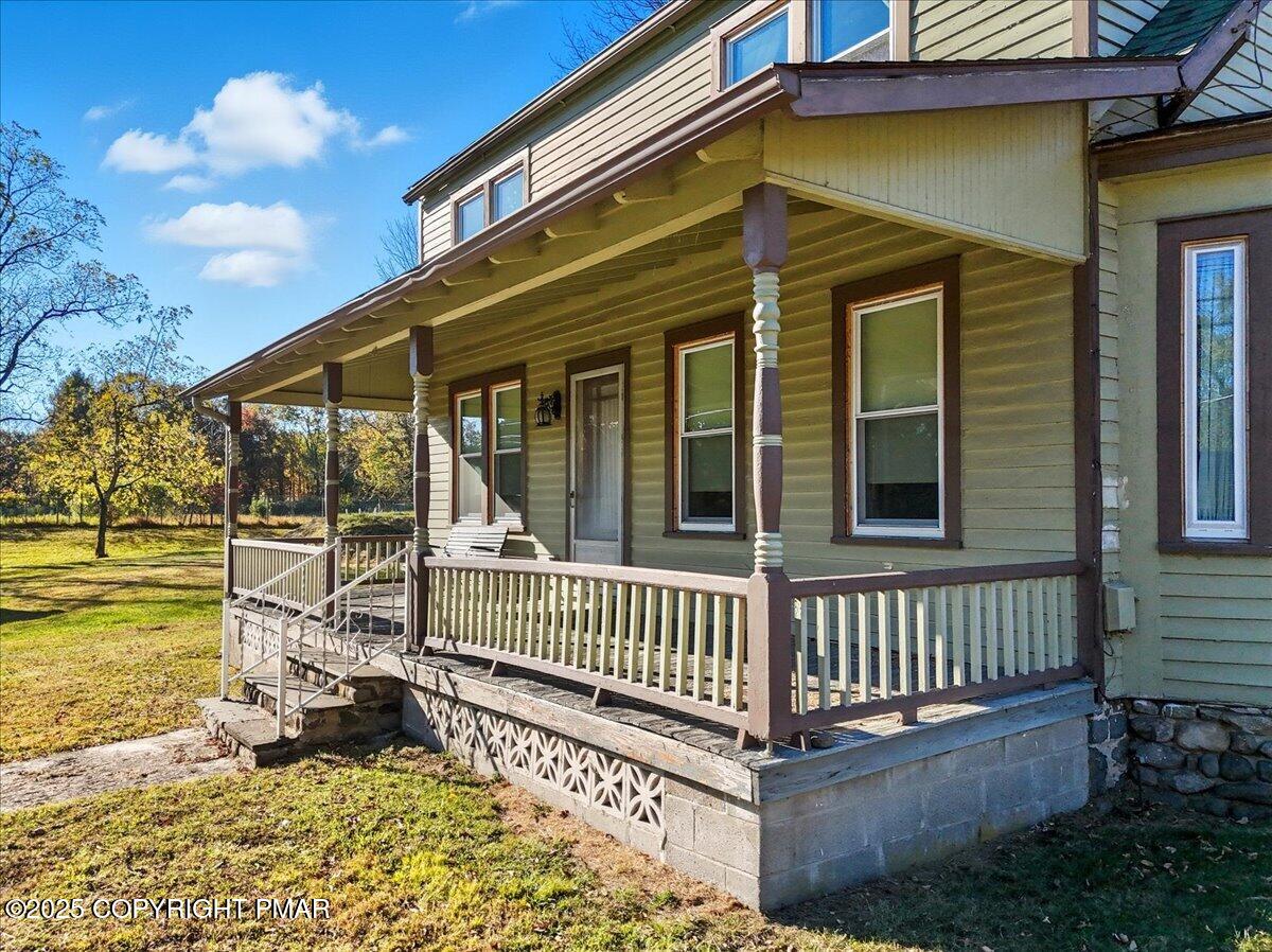 221 Upper Swiftwater Road Mount Pocono, PA 18344 - Photo 7 of 86 a view of a house with a small yard and deck