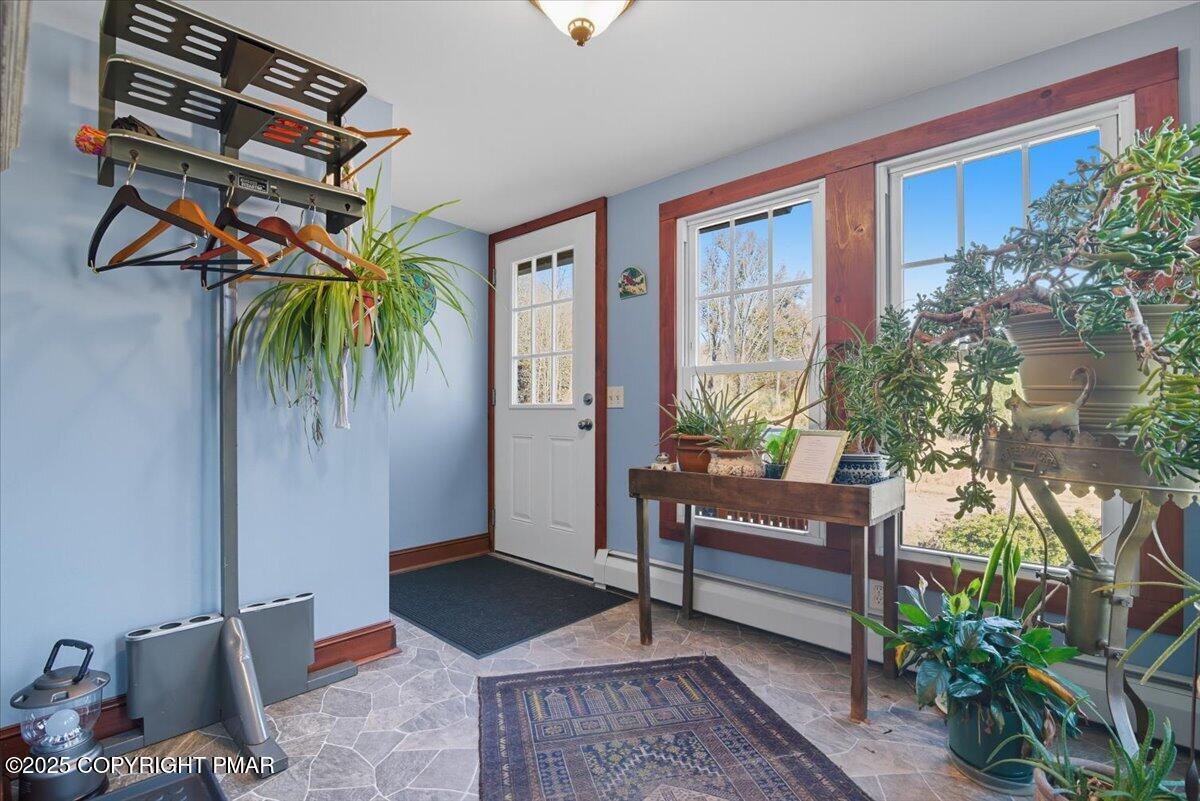 221 Upper Swiftwater Road Mount Pocono, PA 18344 - Photo 9 of 86 a living room with furniture and a potted plant