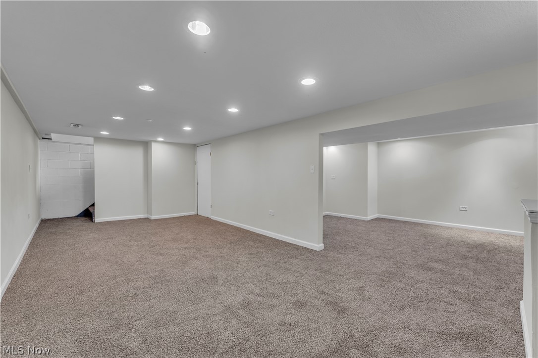 2540 Charney Road University Heights, OH 44118 - Photo 36 of 44 Open finished basement area featuring neutral carpeting, recessed ceiling lighting, and a white concrete block wall