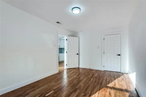 a view of an empty room and wooden floor