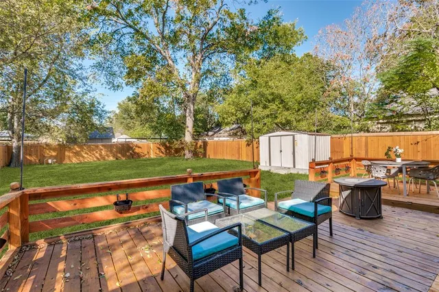 an outdoor sitting area with furniture and garden view