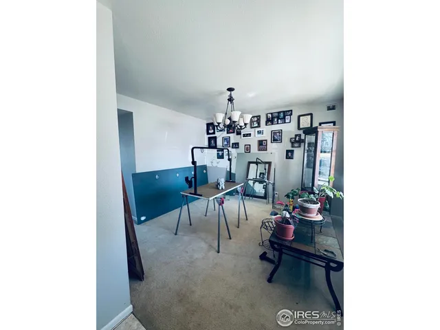 a living room with furniture and a dining table