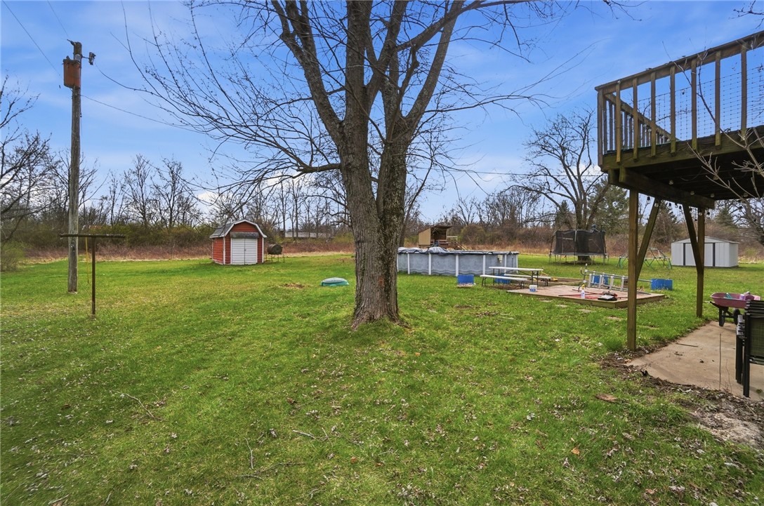 290 Ginghamsburg Road Tipp City, OH 45371 - Photo 47 of 49 This spacious yard offers ample outdoor living possibilities with a deck, shed, and pool.