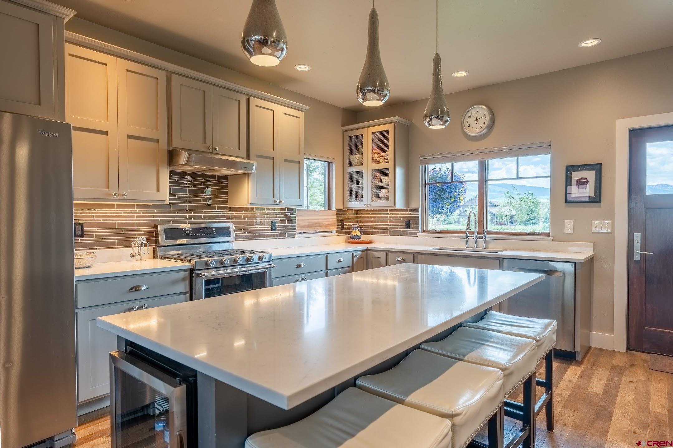 142 Larkspur Loop Crested Butte, CO 81224 - Photo 20 of 35 a very nice looking kitchen with granite countertop a stove two sinks and a refrigerator