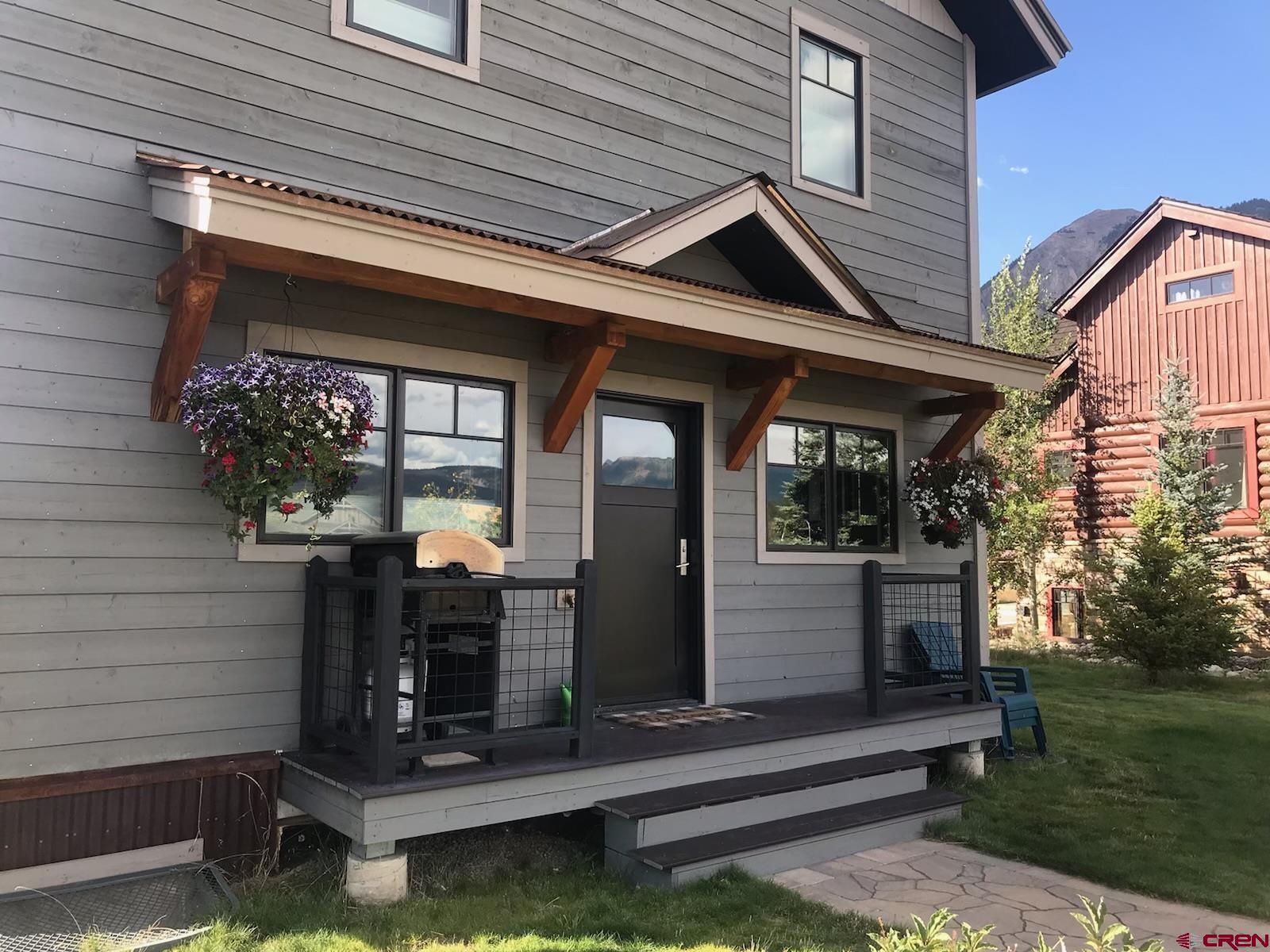 142 Larkspur Loop Crested Butte, CO 81224 - Photo 21 of 35 a front view of a house with a garden