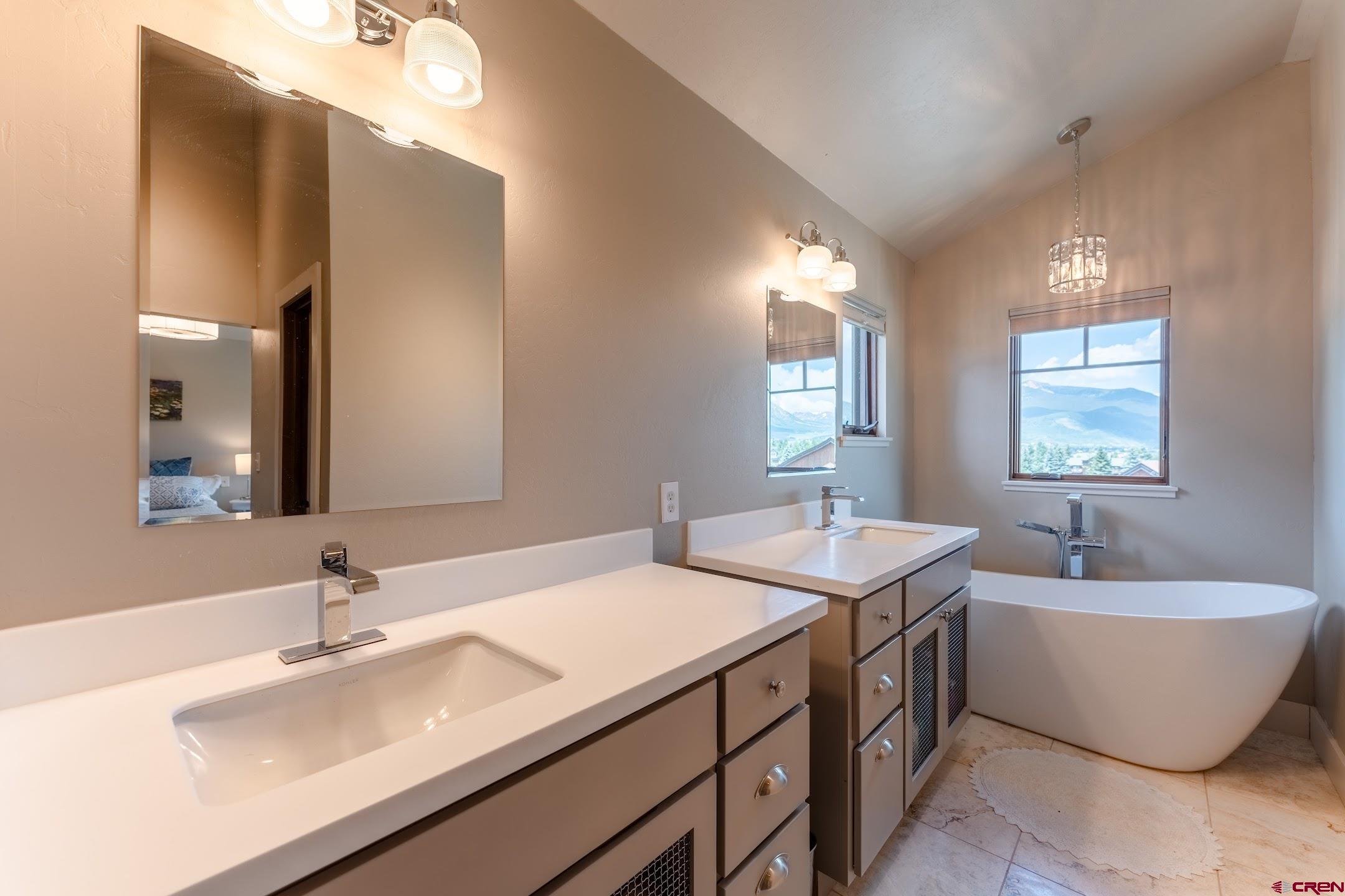 142 Larkspur Loop Crested Butte, CO 81224 - Photo 8 of 35 a bathroom with a tub sink and mirror
