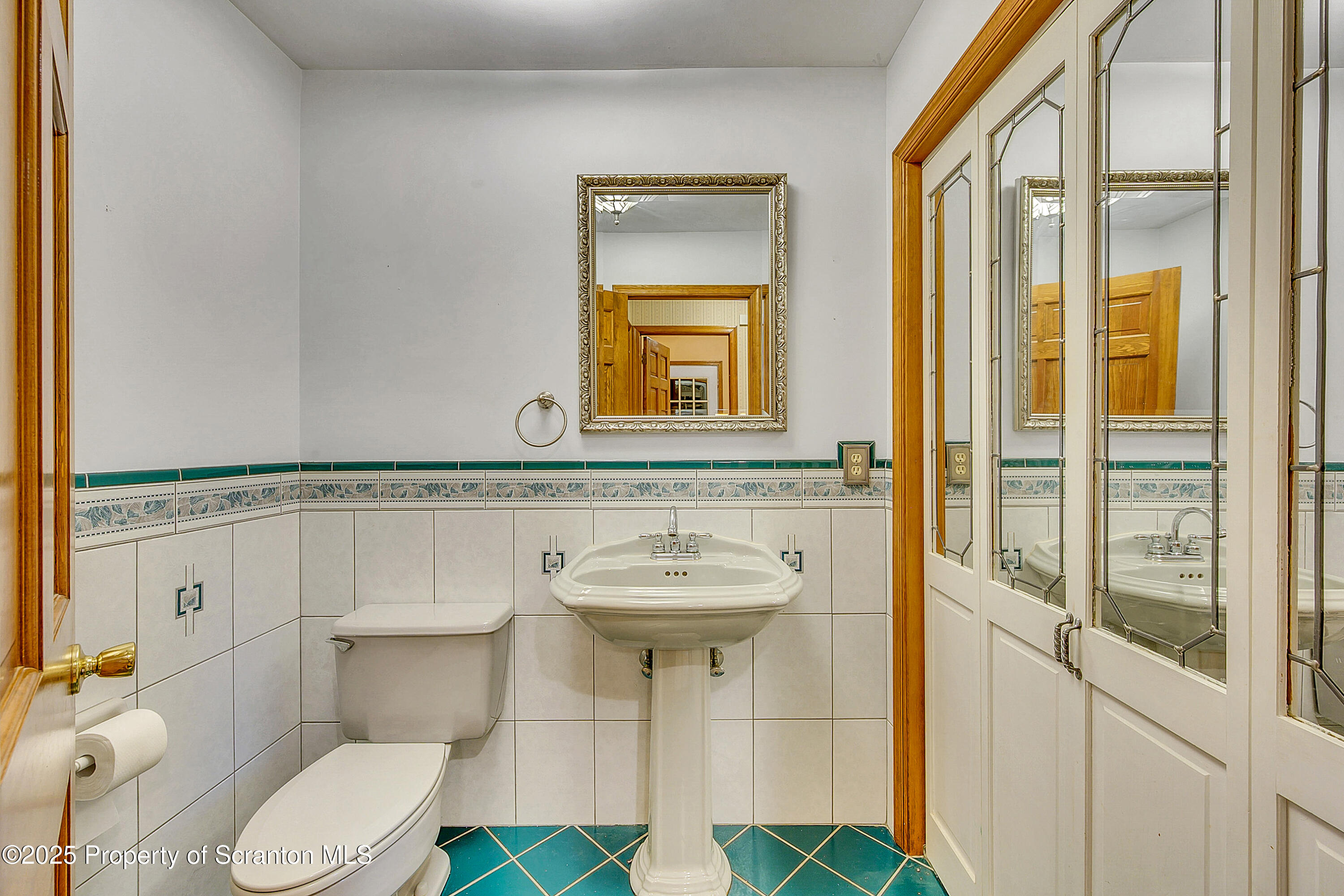804 Fairview Road Clarks Summit, PA 18411 - Photo 30 of 49 a bathroom with a sink a toilet and mirror