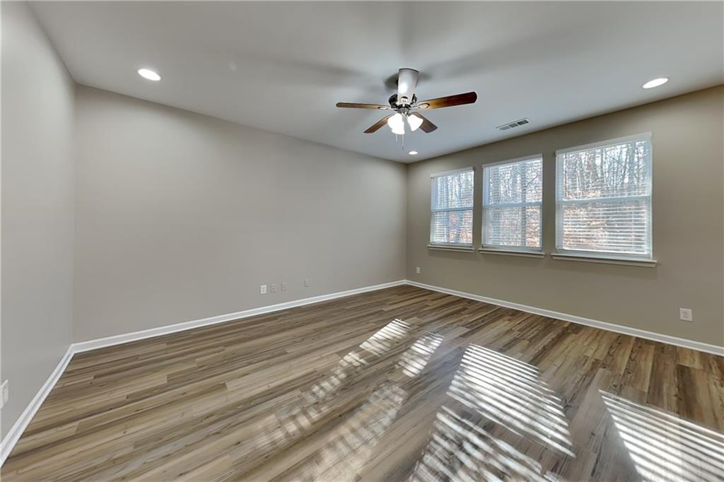 89 Candy Lilly Court Dallas, GA 30157 - Photo 3 of 19 a view of empty room with wooden floor and fan