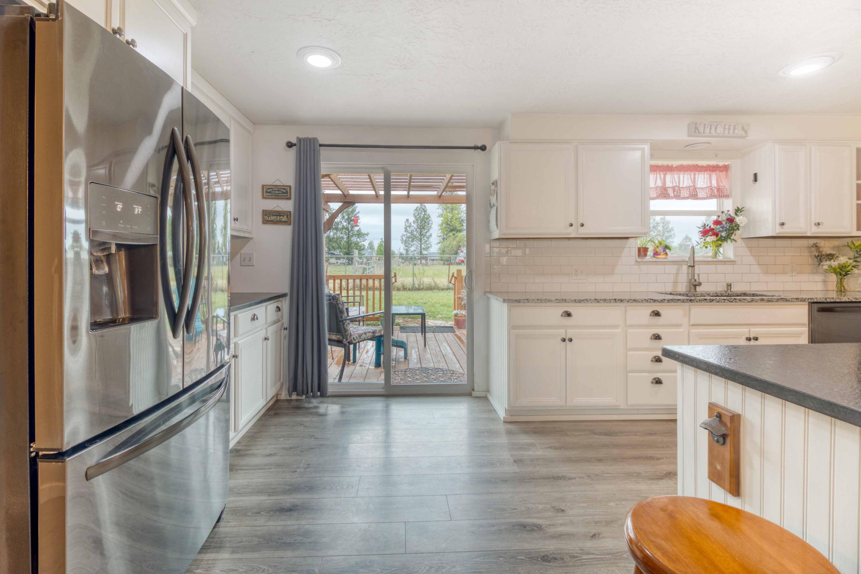 566 Northwest Mc Donald Road Prineville, OR 97754 - Photo 9 of 41 a kitchen with stainless steel appliances a refrigerator sink and cabinets