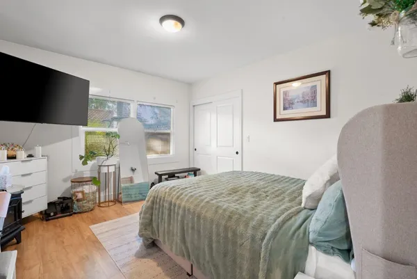 a kitchen with stainless steel appliances granite countertop a stove a sink dishwasher and a refrigerator with wooden floor