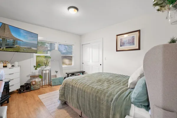 a bedroom with a bed and a window
