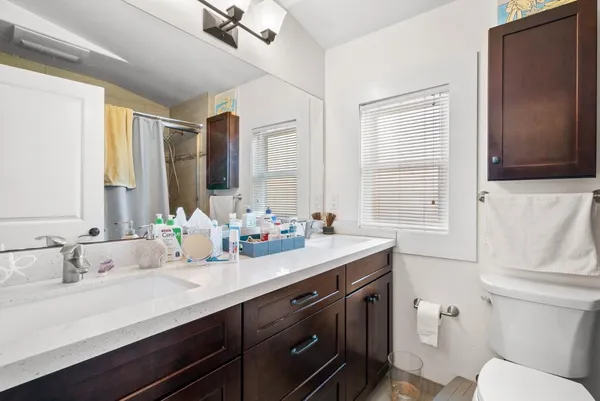 a kitchen with stainless steel appliances a dining table chairs stove refrigerator and cabinets