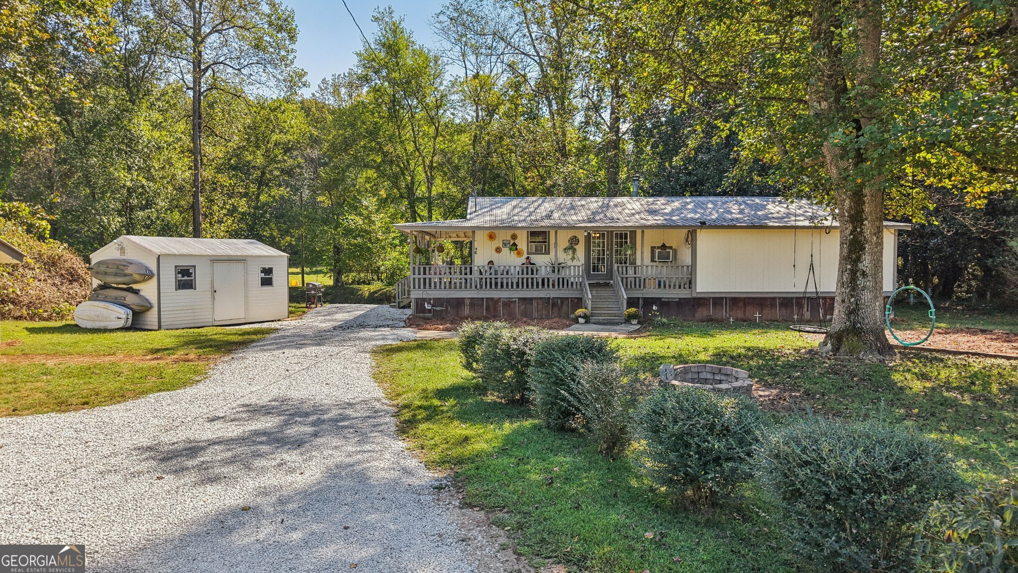 a view of a house with a yard and sitting area