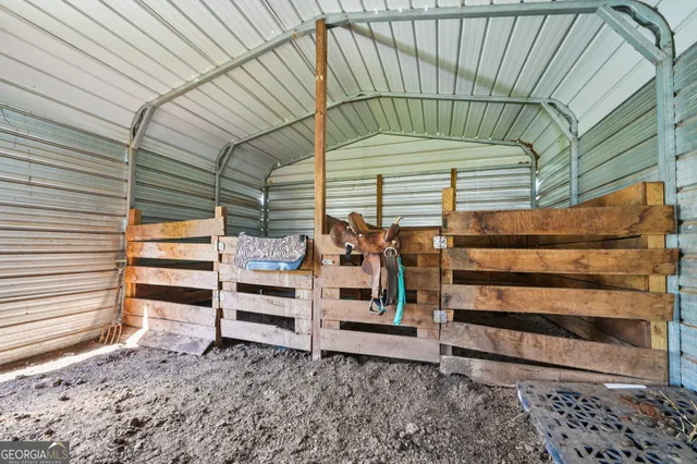 an aerial view of a swimming pool with outdoor seating and yard