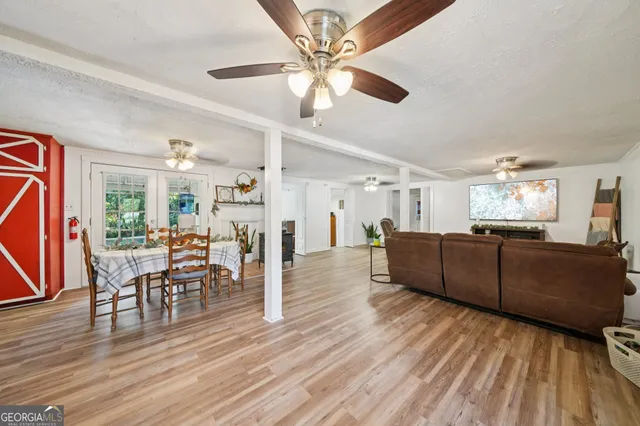 a living room with furniture and a wooden floor