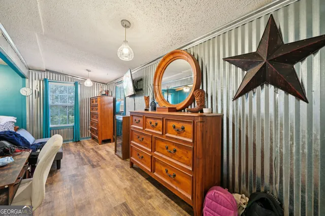 a view of a bedroom with furniture cabinet mirror and a window