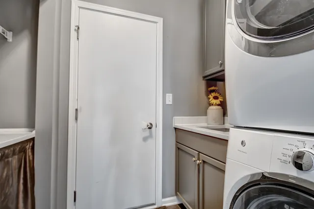 a utility room with sink dryer and washer