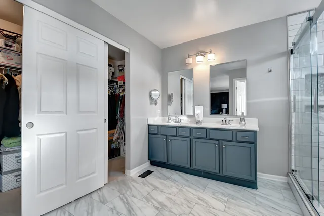 a bathroom with a sink double vanity and a mirror