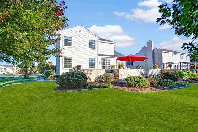 a view of a house with a yard and garden