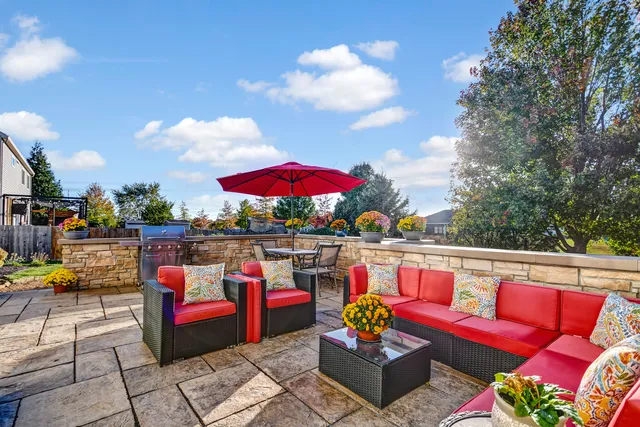 a view of a house with a yard and a garden