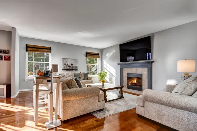 a living room with furniture flat screen tv and a fireplace