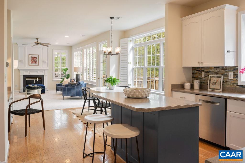 1254 Loring Run Charlottesville, VA 22901 - Photo 12 of 44 a kitchen with stainless steel appliances granite countertop a table chairs and a refrigerator