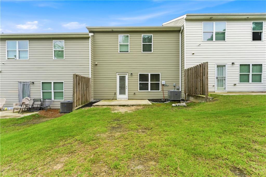 7492 Knoll Hollow Road Lithonia, GA 30058 - Photo 26 of 30 a view of a house with pool and a yard