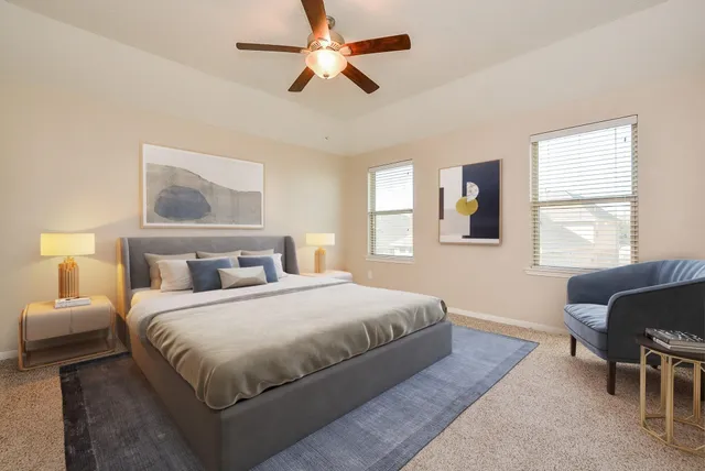 a bedroom with a bed mirror and a window