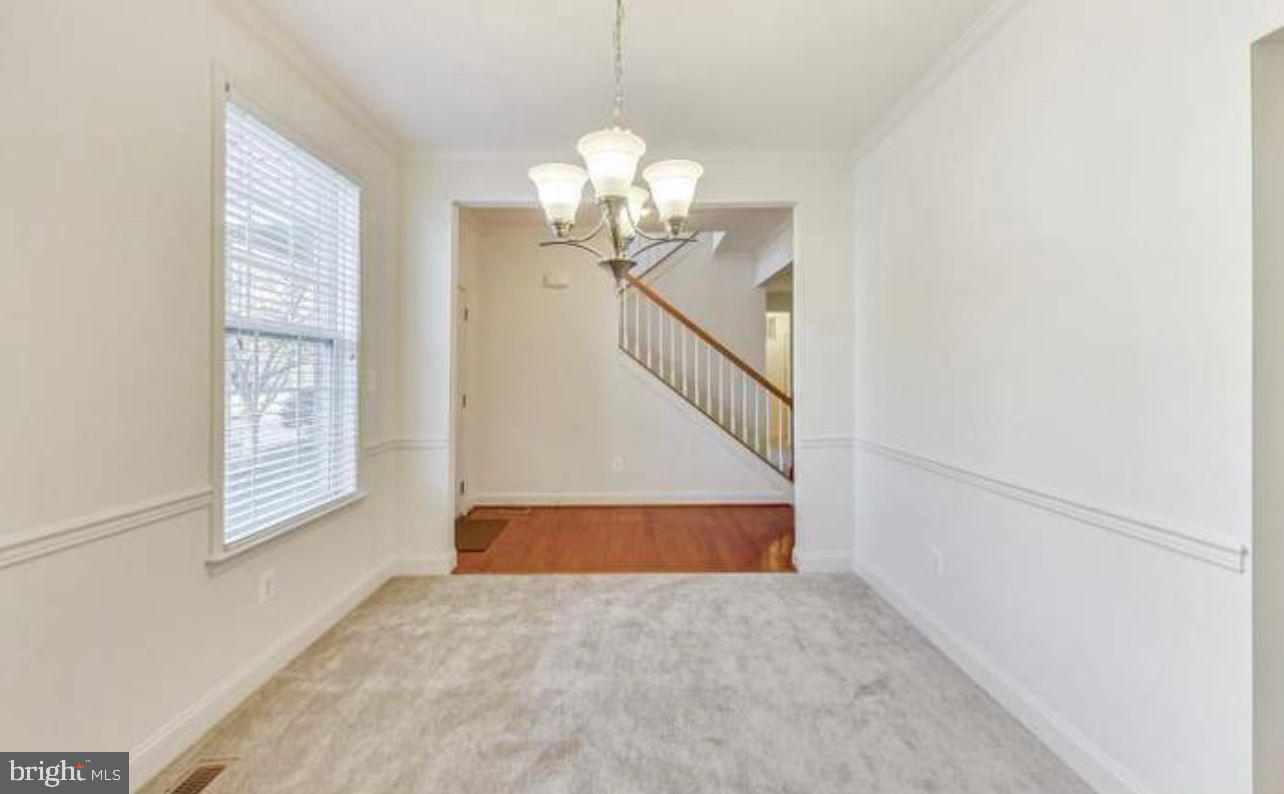 7533 Tottenham Drive White Plains, MD 20695 - Photo 11 of 51 a view of a hallway with windows and chandelier