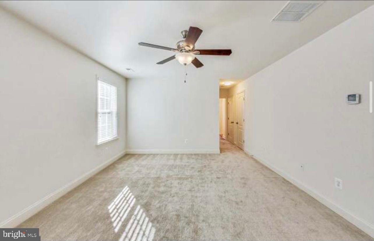 7533 Tottenham Drive White Plains, MD 20695 - Photo 23 of 51 an empty room with windows and fan