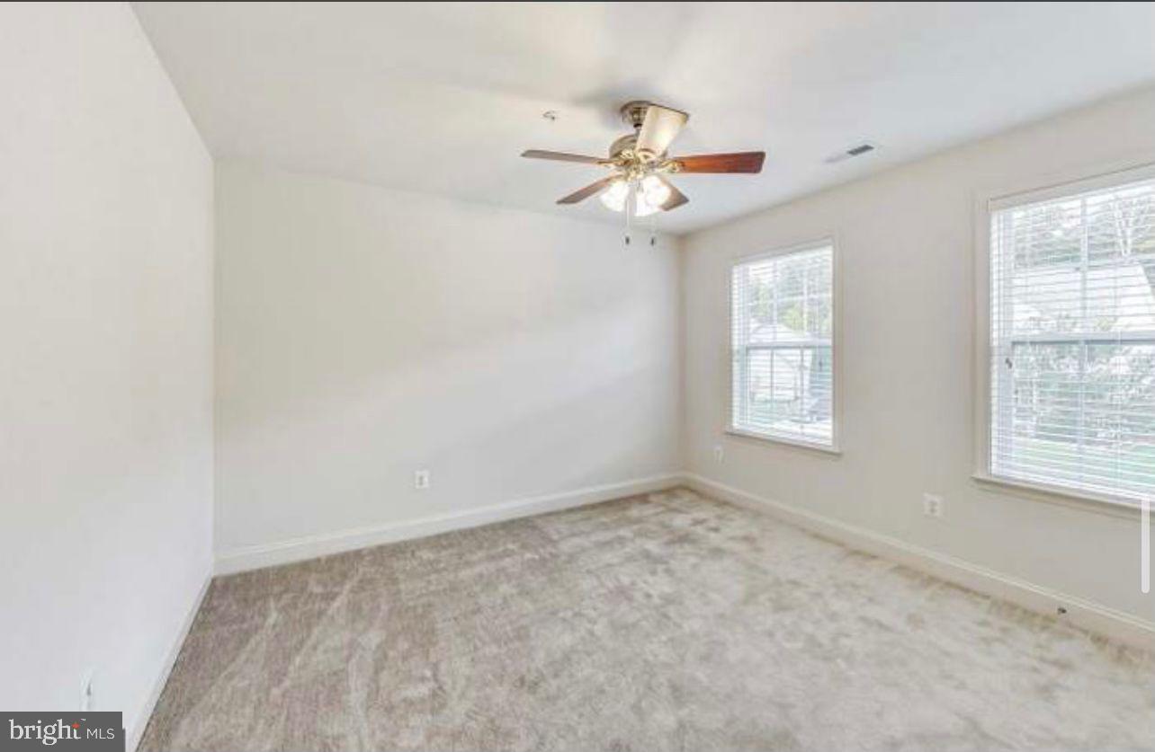 7533 Tottenham Drive White Plains, MD 20695 - Photo 25 of 51 an empty room with windows and fan