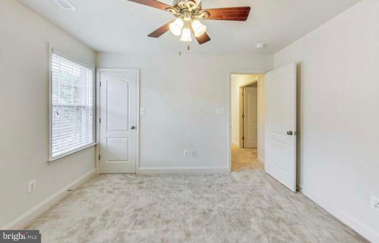 7533 Tottenham Drive White Plains, MD 20695 - Photo 26 of 51 an empty room with closet and a chandelier fan