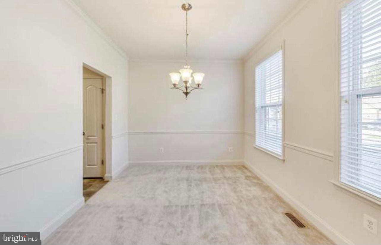 7533 Tottenham Drive White Plains, MD 20695 - Photo 6 of 51 a view of a hallway with windows and chandelier