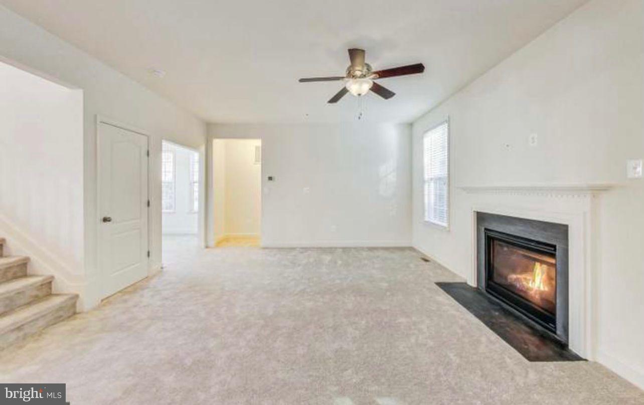 7533 Tottenham Drive White Plains, MD 20695 - Photo 9 of 51 a view of an empty room with chandelier fan and fire place